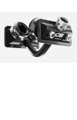 Close-up of a black and silver metal mechanical device with bolts, a gear-like knob, and the letters "CM" on its housing.