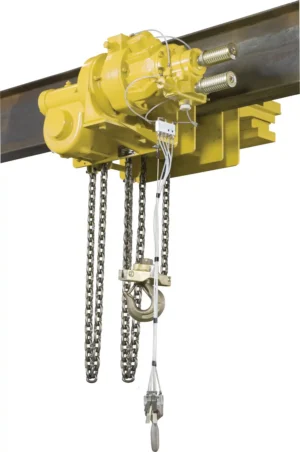 A yellow industrial hoist with attached chains and control wiring mounted on a steel beam.