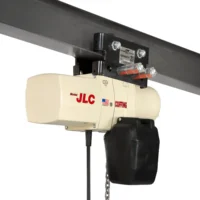 A CM Coffing Model JLC electric chain hoist is mounted on a steel I-beam trolley, with capacity label and chain bag visible.