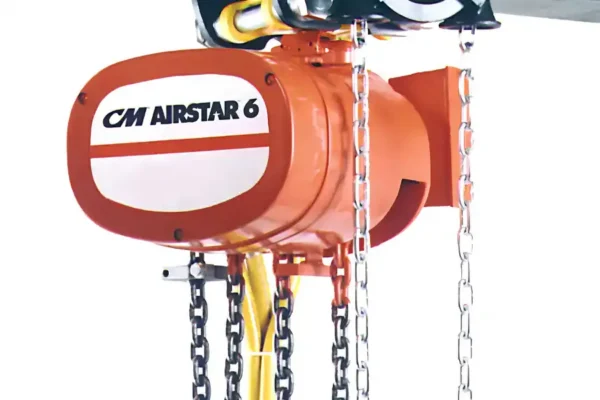 Close-up of an orange CM Airstar 6 hoist with metal chains hanging down, used for lifting heavy objects.