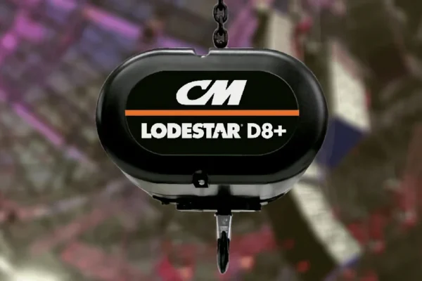 A close-up of a CM Lodestar D8+ hoist with a hook, set against a blurred background with purple and red tones.