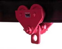 A red industrial trolley hoist is attached to a horizontal beam, designed for lifting or moving heavy loads.